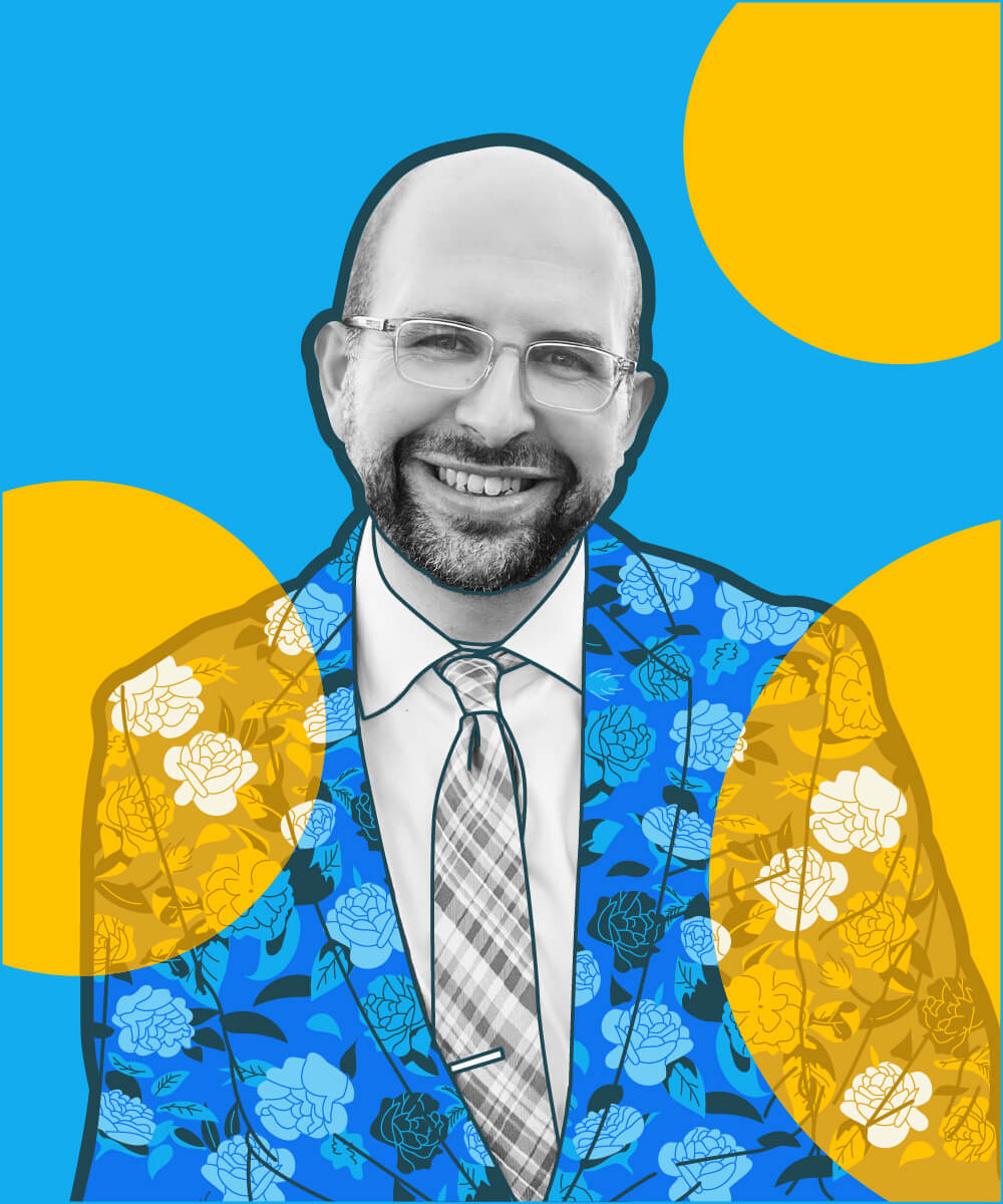 Zvi Band wearing an illustrated floral blazer, overlapped in gold decorative circles